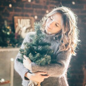 woman enjoying holiday tree