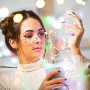 young woman arranging holiday lights