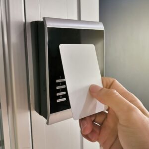 Holding a key card up to an electronic door lock panel
