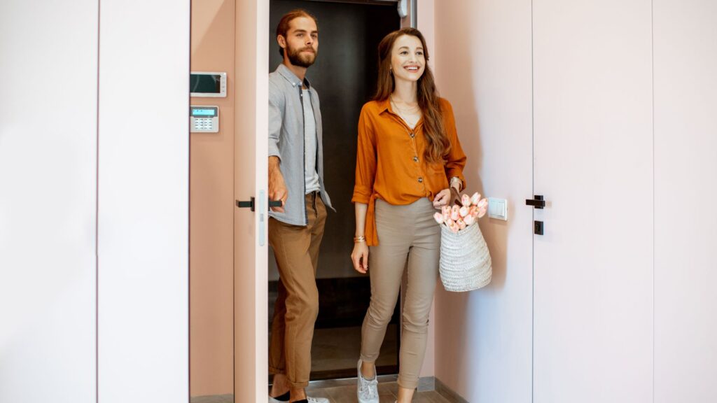 young couple walking into apartment