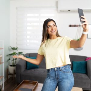 woman showing off new apartment on phone