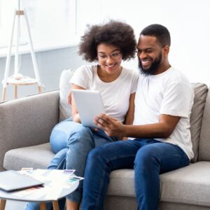 couple reviewing finances on tablet