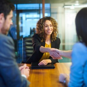 a woman shaking hands with interviewers