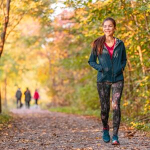 a woman walking along a trail
