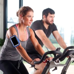 a man and woman on exercise bikes