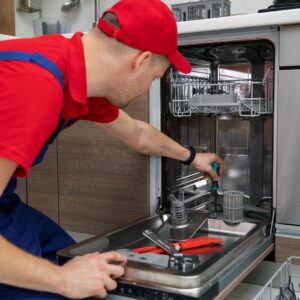 a maintenance man fixing a dish washer