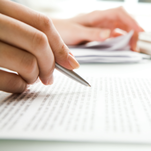 Person signing paperwork. 