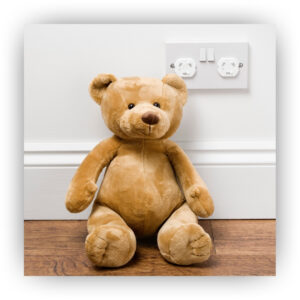 Teddy bear and a covered outlet