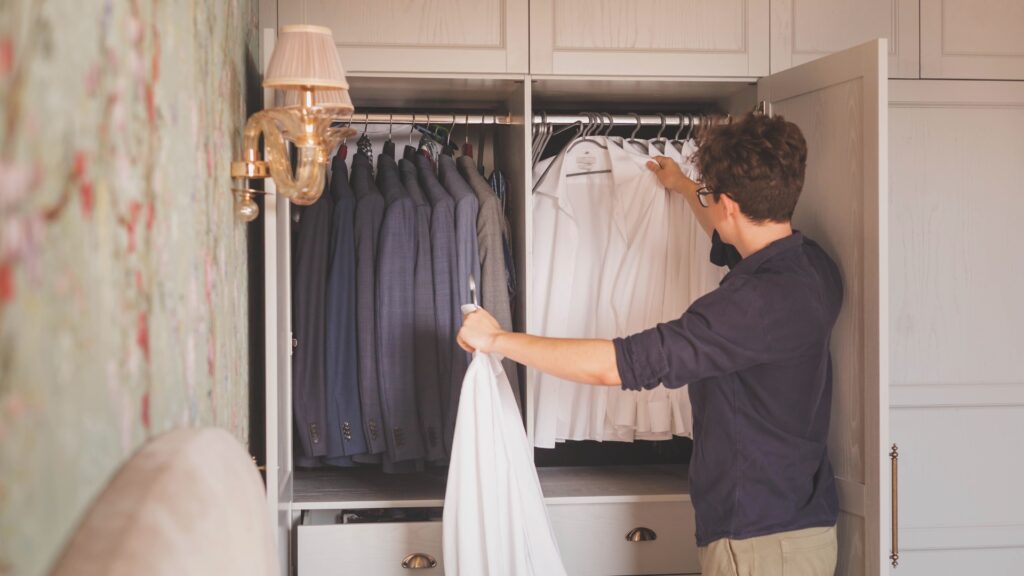 Person picking out clothes from a closet