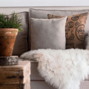 couch will pillows and fluffy white blanket