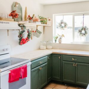 kitchen with red accents and wreaths hanging