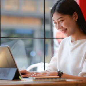 woman looking at floor plans on laptop