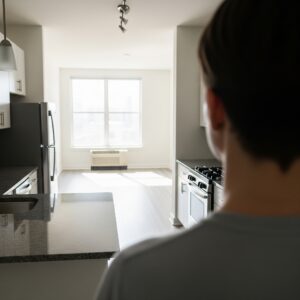 Viewing the modern kitchen of a vacant apartment during a tour.